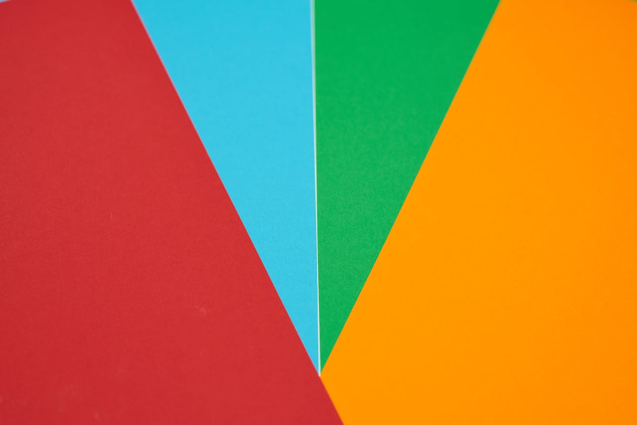 about-us Colorful abstract design featuring red, blue, green, and orange geometric shapes.